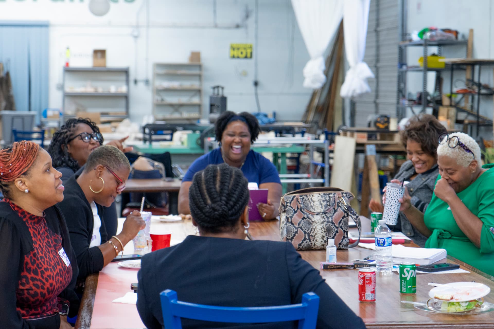Women sharing conversation and laughter around a table at a WFS gathering